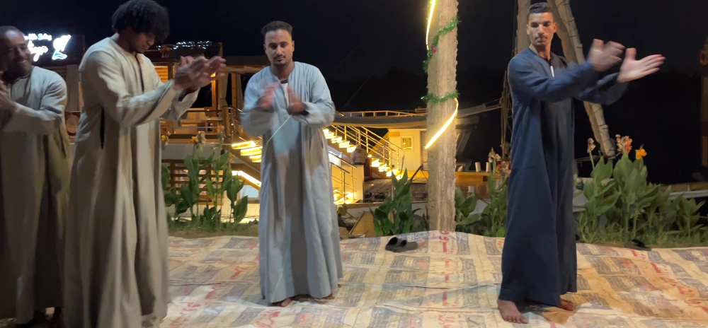 The crew dancing on the banks of the Nile at Ramadi Village